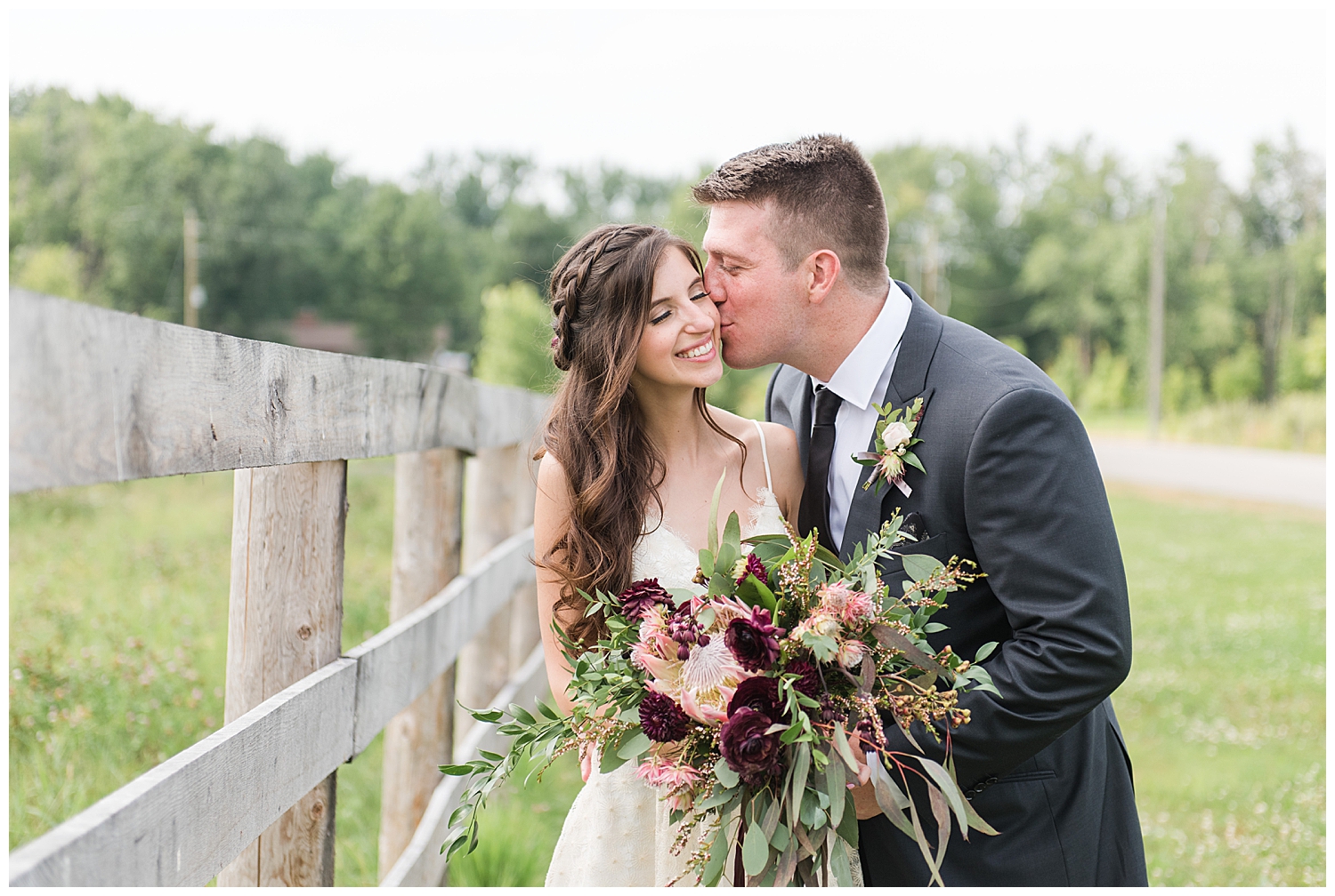 bride kissing groom at earth to table farm