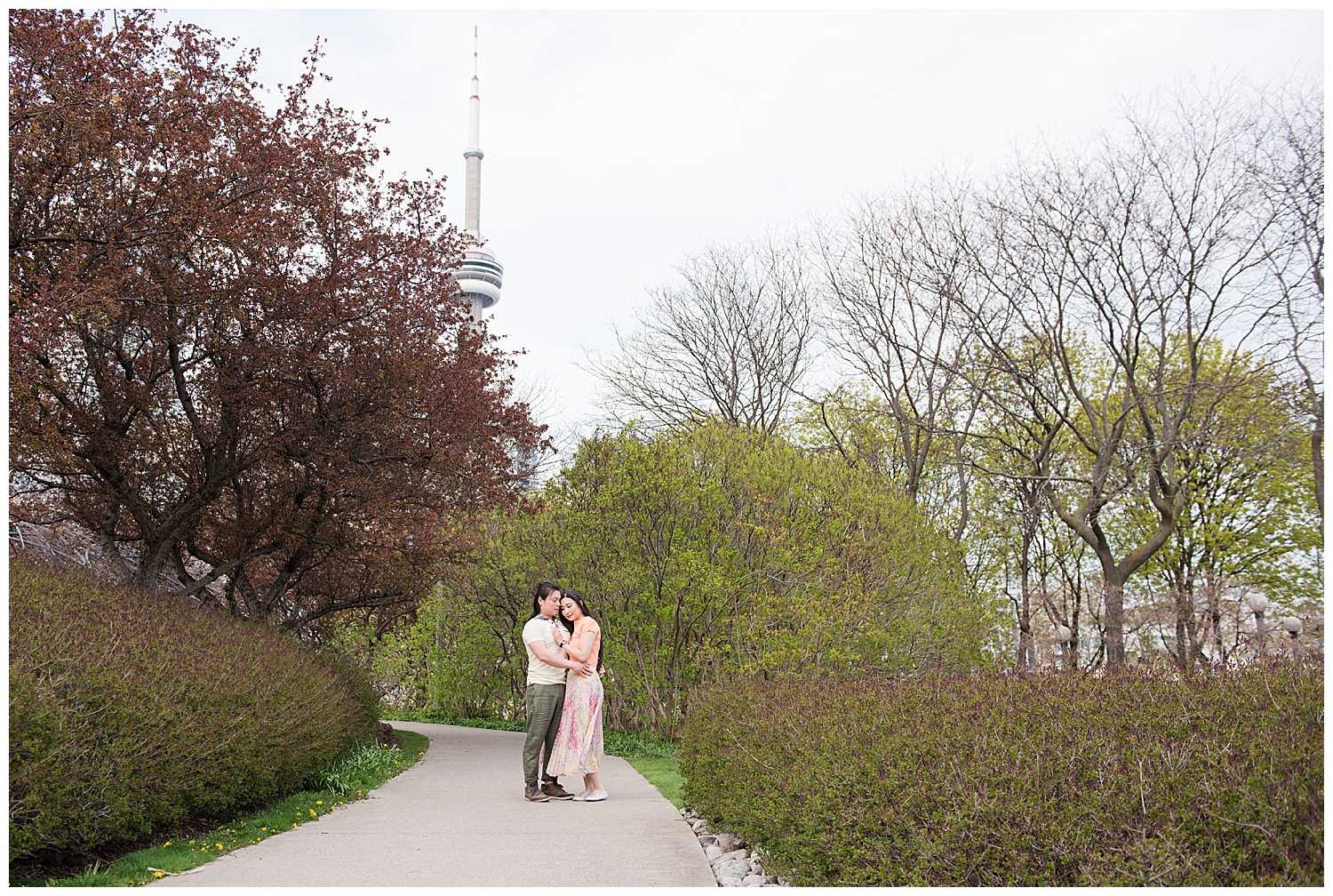 couple standing with CN tower in background